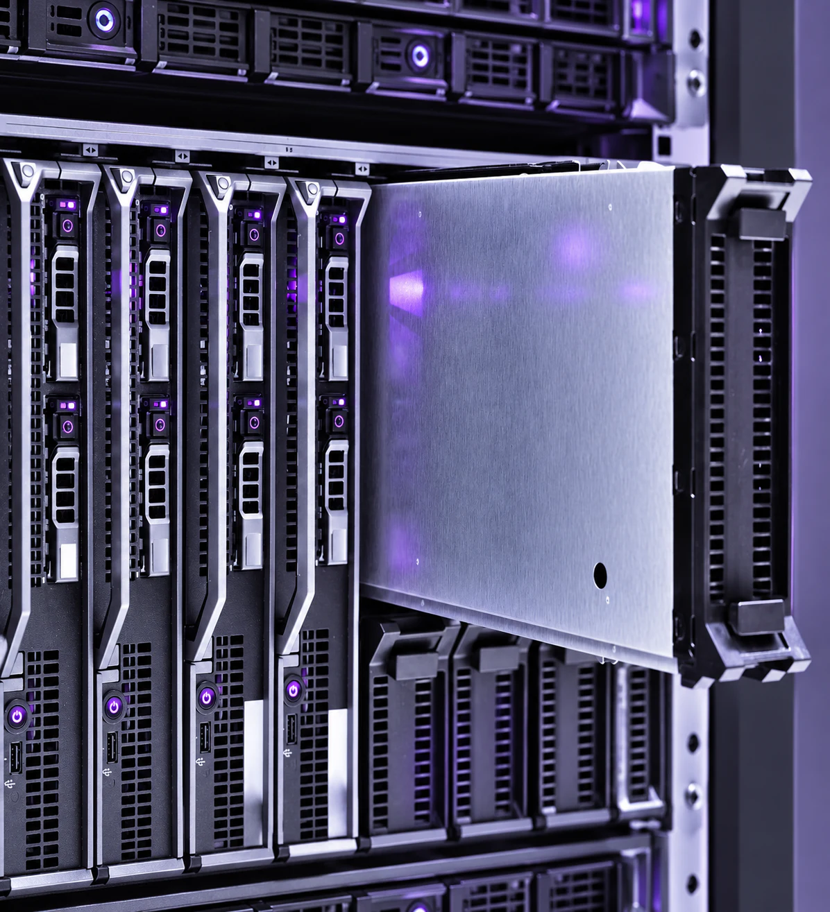 Enterprise server hardware with metal drive bays and restrained violet illumination.